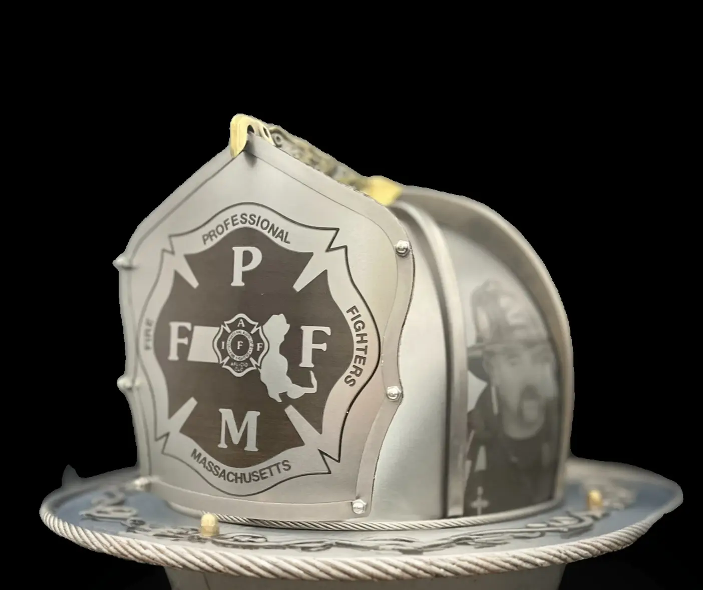 Close-up detail of hand-engraved steel on a Torched Steel custom firefighter helmet